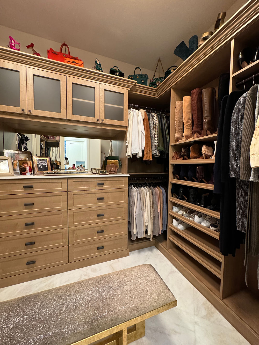 Custom closet organization system with neatly arranged clothing and accessories