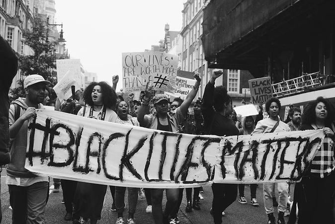 np_London, England, United Kingdom - June 6th, 2020_ group of people carry banner for BLM