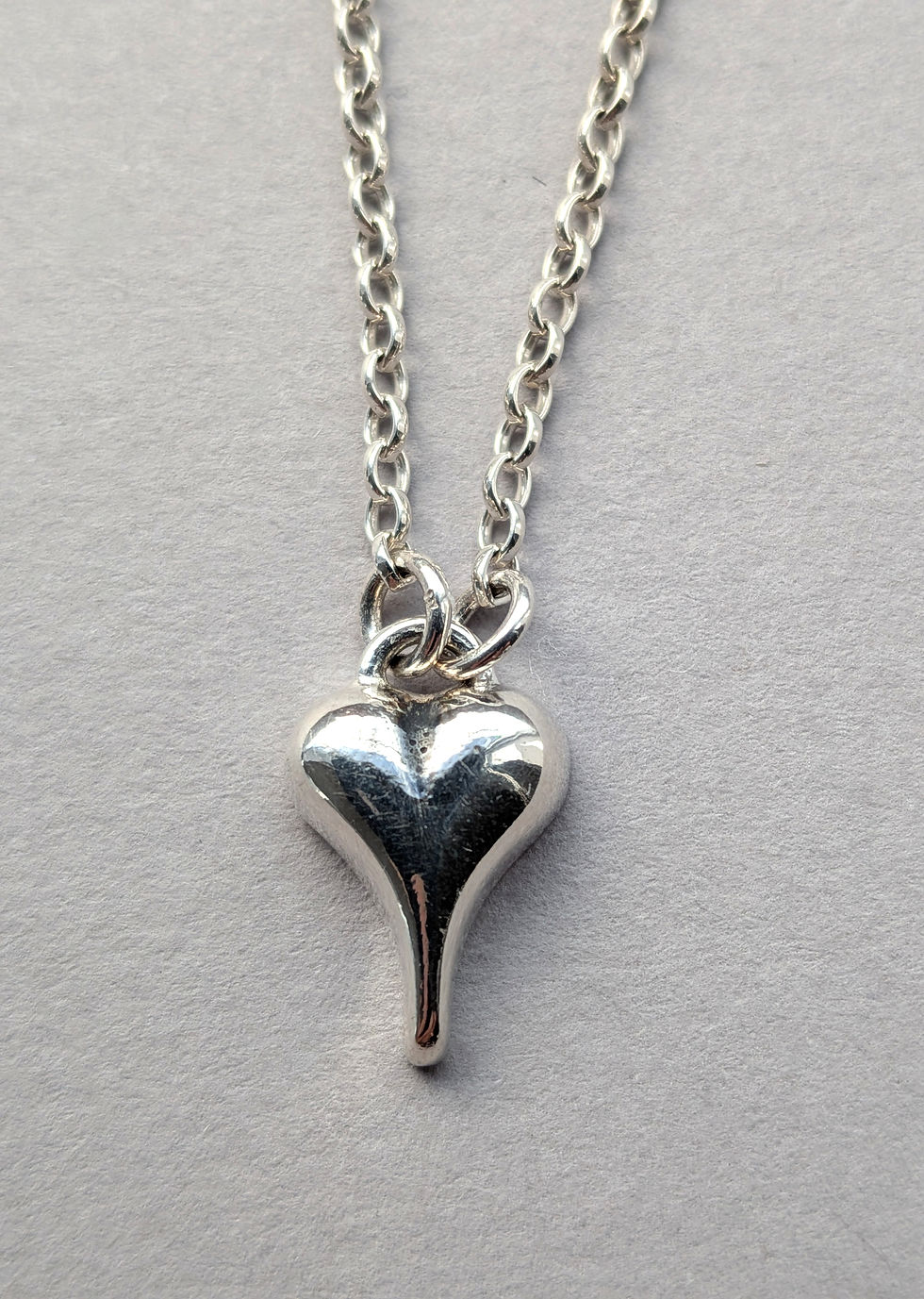 Sweet Hearts Pointy Heart pendant against a grey background