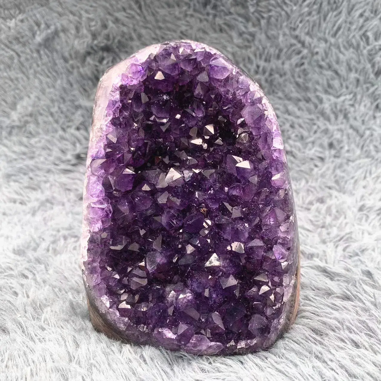 Natural amethyst and quartz geode cluster with sparkling crystal interior