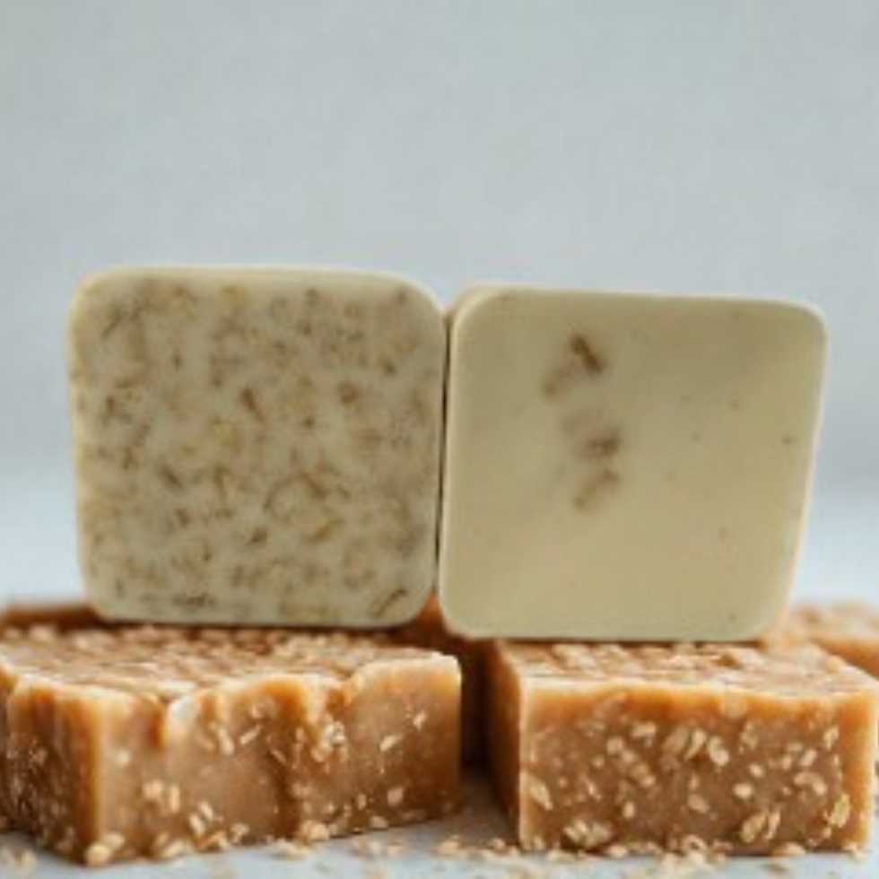 Close-up of oatmeal soap lathering in hand, showing soft exfoliation