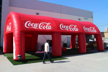 Red inflatable tent featuring Coca-Cola branding, ideal for promotional events.