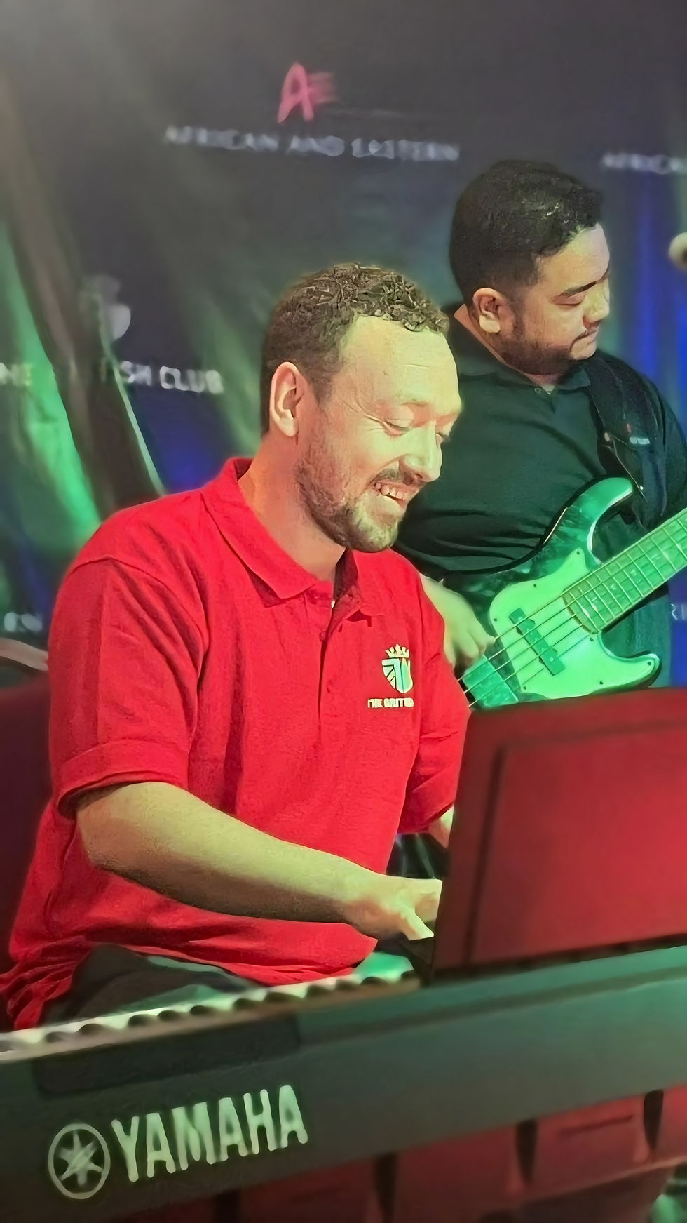 Teacher playing keyboard for a live concert.
