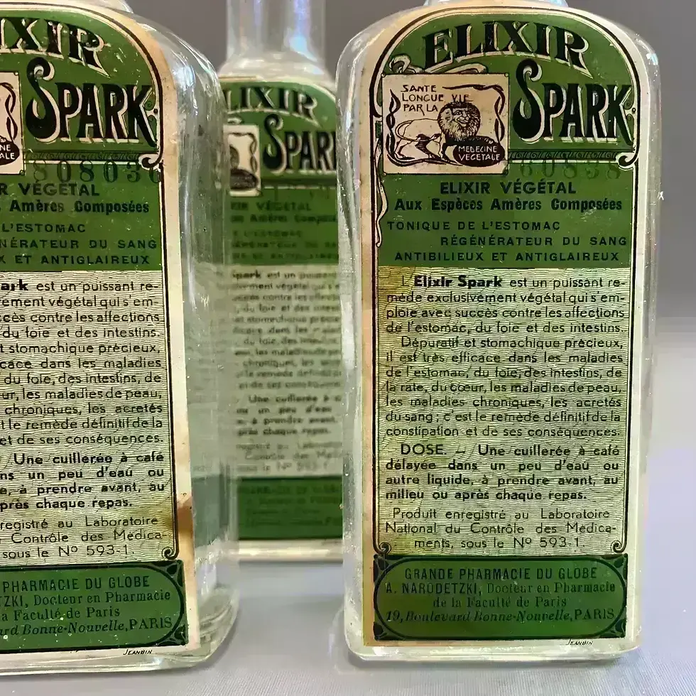 3 bouteilles vides Elixir Spark Grande Pharmacie du Globe, étiquettes