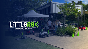 Children ride toy cars near a tent with adults watching. Green cones line the path. Text: "Little Rex Ride On Car Hire." Sunny day.