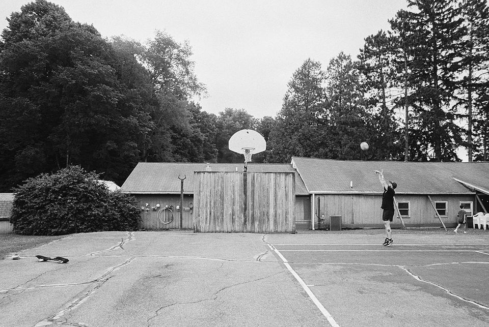 Documentary wedding photographs in black and white 35mm film of a summer camp themed ceremony and reception in Watervliet, Michigan at Renora Lodge.