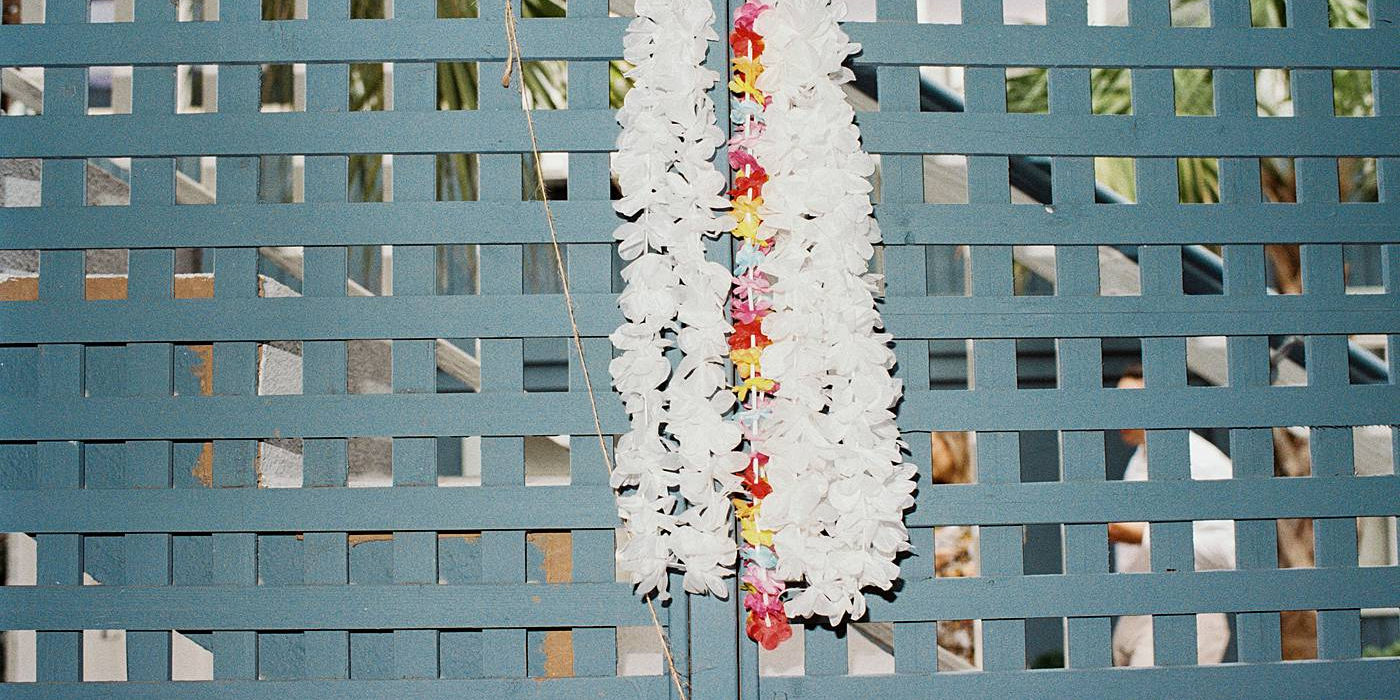 Hawaiian Leis await guests as they are greeted entering a wedding reception at The Folliday Inn. Captured with film by Smith Brian.