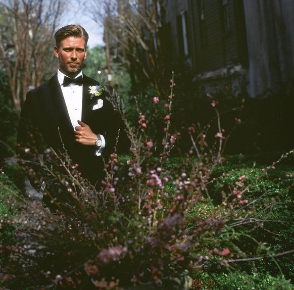 kodak ektachrome 100 medium format film portrait of a groom dressed in black tie, shot at his downtown elopement in Charleston, South Carolina. Groom is front lit by the sun, looking into camera. 