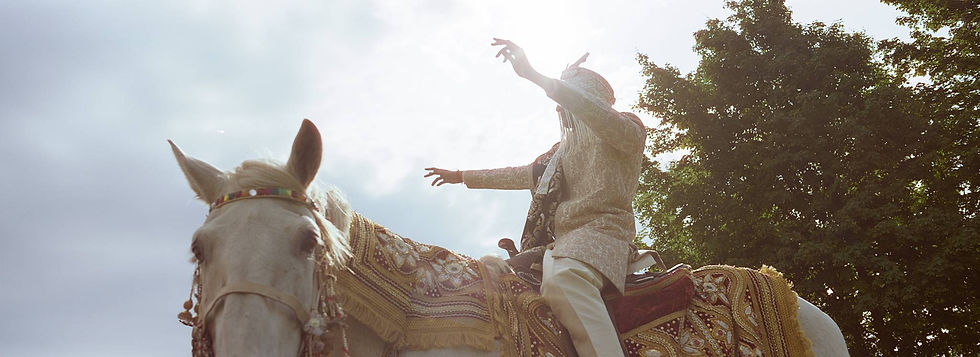 A groom riding a horse during Baraat at an Indian wedding in Traverse City, Michigan