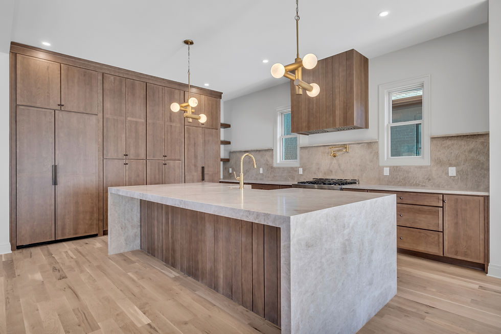 Modern kitchen with a large island and wooden cabinetry. Elegant design. Rachel Exline helped sell this home.