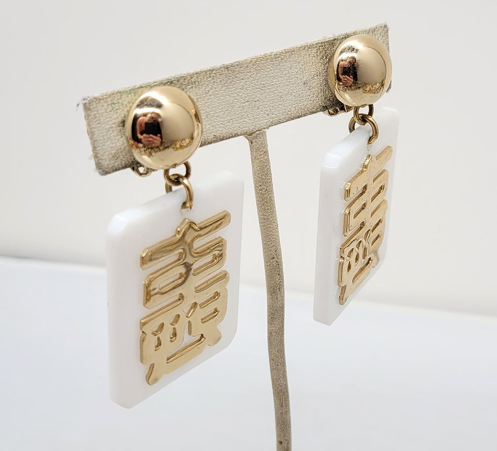Thumbnail: Vintage 1970s Signed Napier Goldtone Asian White Resin Pendant Clip Earrings