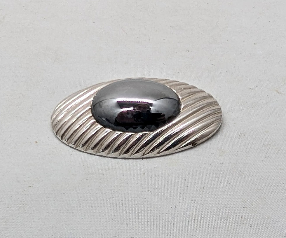 Thumbnail: Vintage 1980s Signed Trifari Oval Rhodium Plated Cabochon Faux-Hematite Brooch