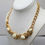 Thumbnail: Vintage 1980s Signed Monet Goldtone White Cabochon Collar Necklace