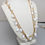 Thumbnail: Vintage 1960s Signed Napier Goldtone & White "Petal" Charms Necklace