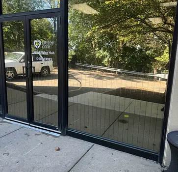 Custom gold frosted vinyl privacy film for a Dallas-Fort Worth (DFW) executive office, featuring a metallic satin finish and precision-cut brand logo for a luxurious North Texas interior.