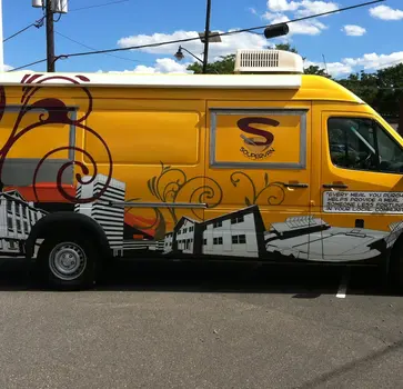 Full food truck vinyl wrap with matte finish graphics for a popular Dallas, TX mobile eatery, creating an eye-catching and appetizing brand identity at local events.