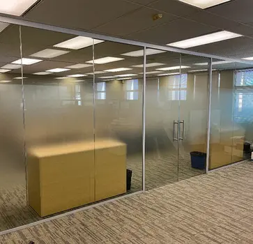 Architectural frosted window film with a "dusted crystal" finish for a Plano corporate interior, featuring precision-cut distraction markers for a sleek Metroplex workspace.