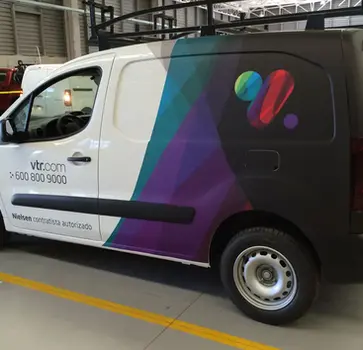 Commercial vinyl wrap fleet branding on a group of Nissan NV cargo vans in Frisco, TX, showcasing consistent company colors and professional design using premium cast vinyl.