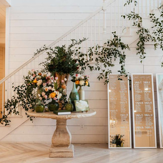 sign in table with a backdrop of greenery at The Nest at Ruth Farms