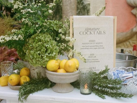 Elegant summer soirée tablescape featuring linen linens, stoneware plates, tapered candles, and fresh seasonal florals under soft evening light.