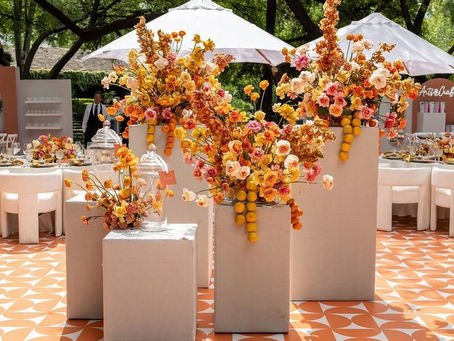 Alt Text for Kait Pena photo: “Elegant summer wedding ceremony setup with sculptural chairs and minimal floral details, styled for a refined outdoor celebration.” Alt Text for A Sparkly Life for Me photo (chair/floral focus): “Close-up of a sculptural chair and thoughtfully arranged summer florals in modern vessels—an example of luxe minimalism in wedding design.” Alt Text for Harold Rojas photo (color palette focus): “Bold and expressive summer wedding table featuring red and burnt orange florals, showcasing rich cultural storytelling through color.” Alt Text for A Sparkly Life for Me photo (eco-conscious section): “Sustainable summer wedding table with locally sourced flowers and natural textures, designed for an eco-conscious celebration.”