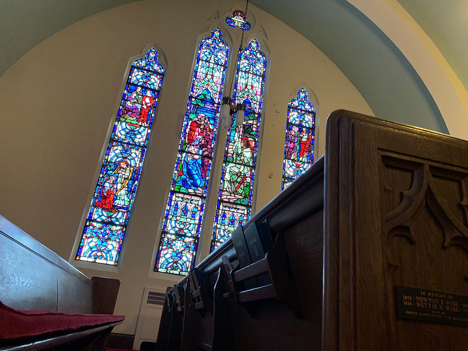 View of the Eastertide set of stained glass windows from the pews.