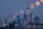 Buck full moon rising over London skyline, England