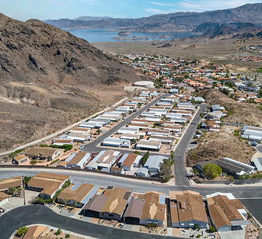 Aerial view of a residential area near desert mountains.