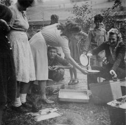 Waiern Summer Camp, Camp Leader Clare McMurray dishing up to Elka Sept.1949