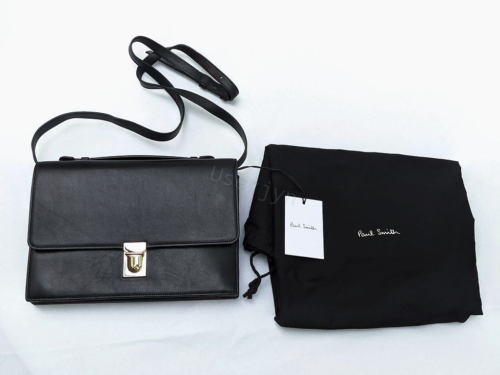 Thumbnail: Black Paul Smith shoulder bag and dust bag against a white background.