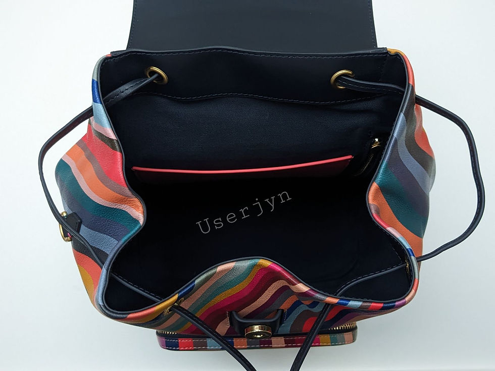 Thumbnail: Open Paul Smith backpack showing inside compartment with Userjyn text detail.