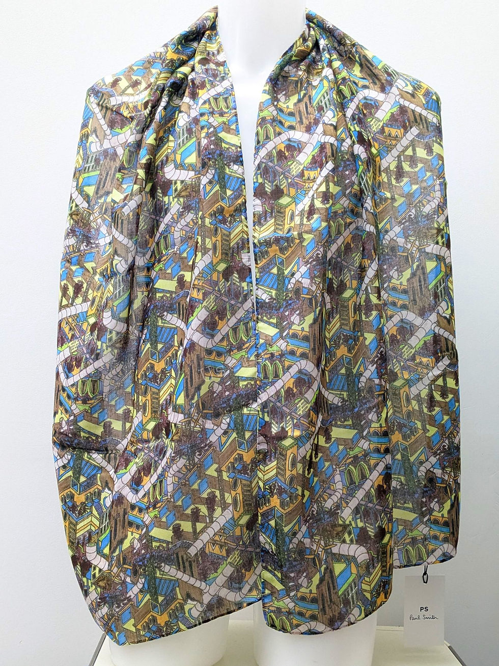 Thumbnail: Abstract pattern scarf with brown, blue, yellow, and white colors; draped garment.