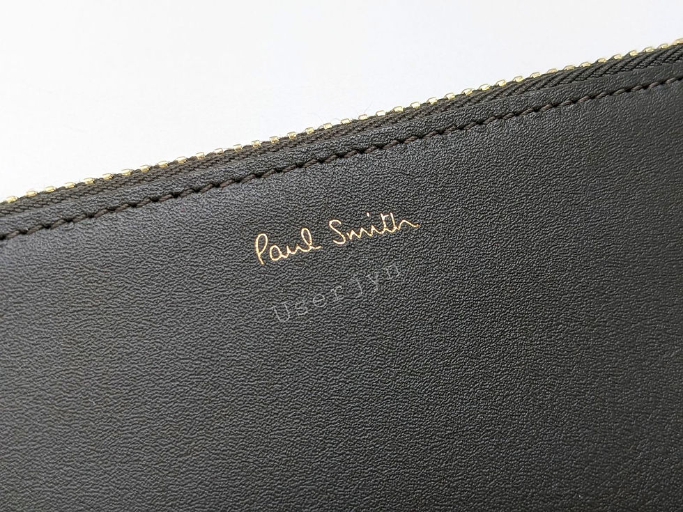 Thumbnail: Close up Paul Smith logo with Userjyn text on a dark leather bag
