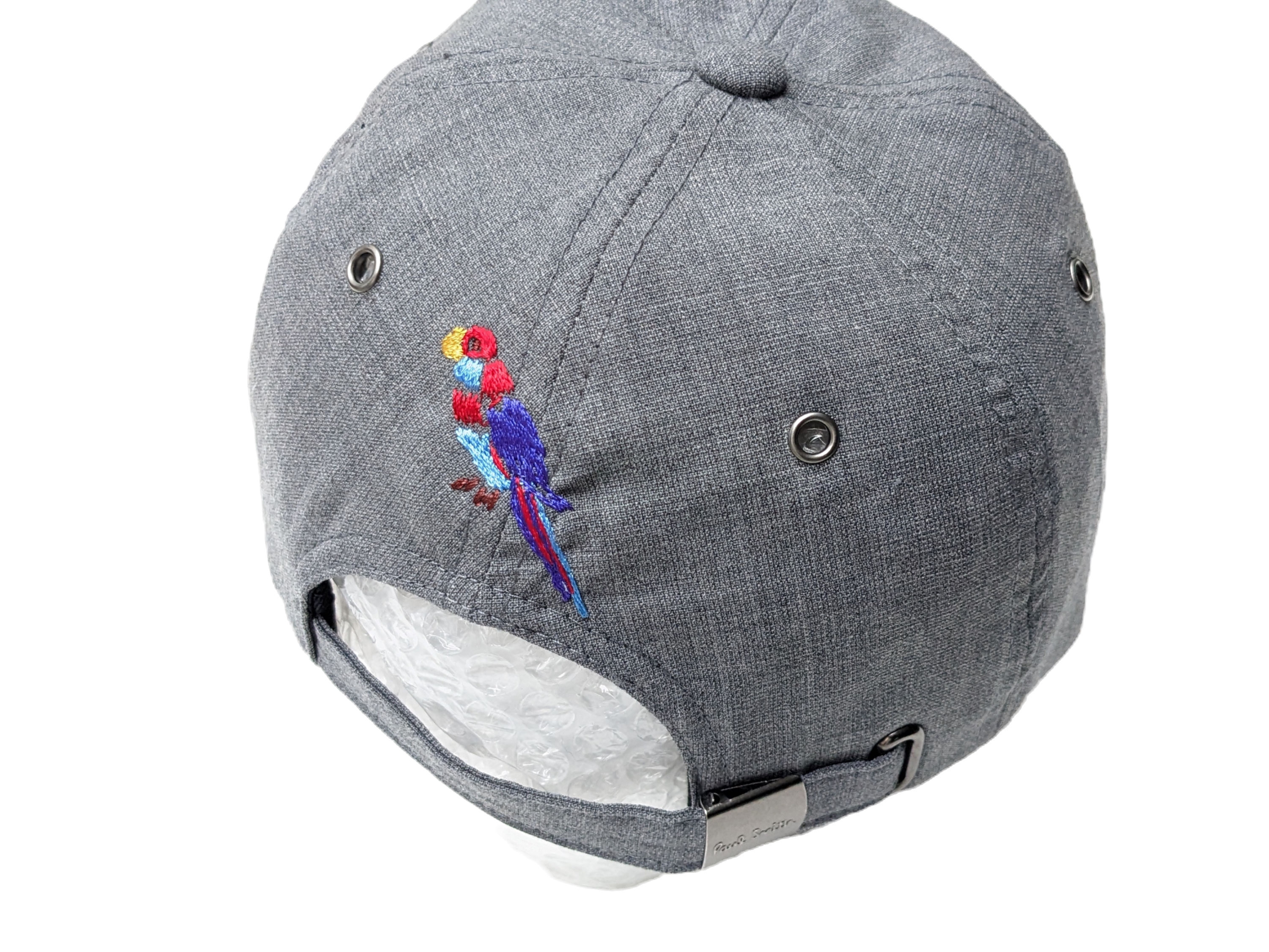 Back of a grey Paul Smith cap with parrot embroidery