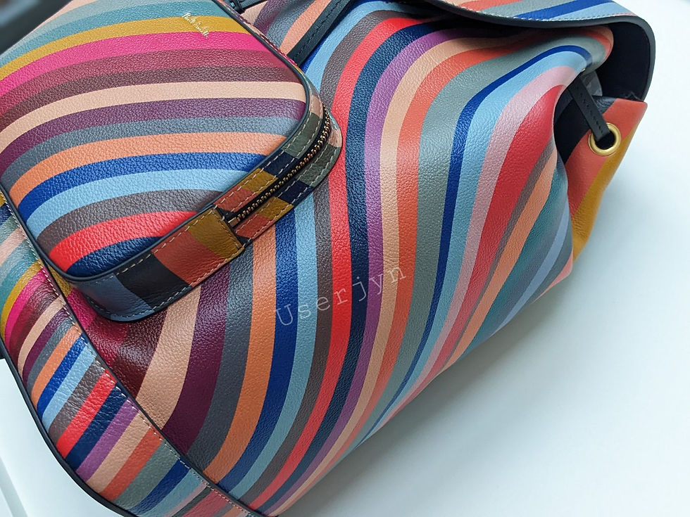Thumbnail: Colorful striped leather bag close-up. 