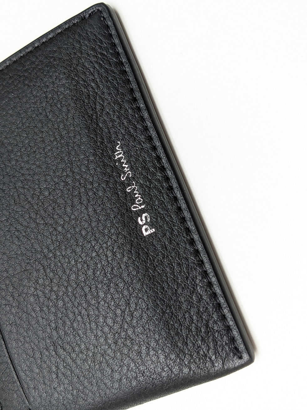 Thumbnail: Black pebbled leather texture with 'PS Paul Smith' silver logo.