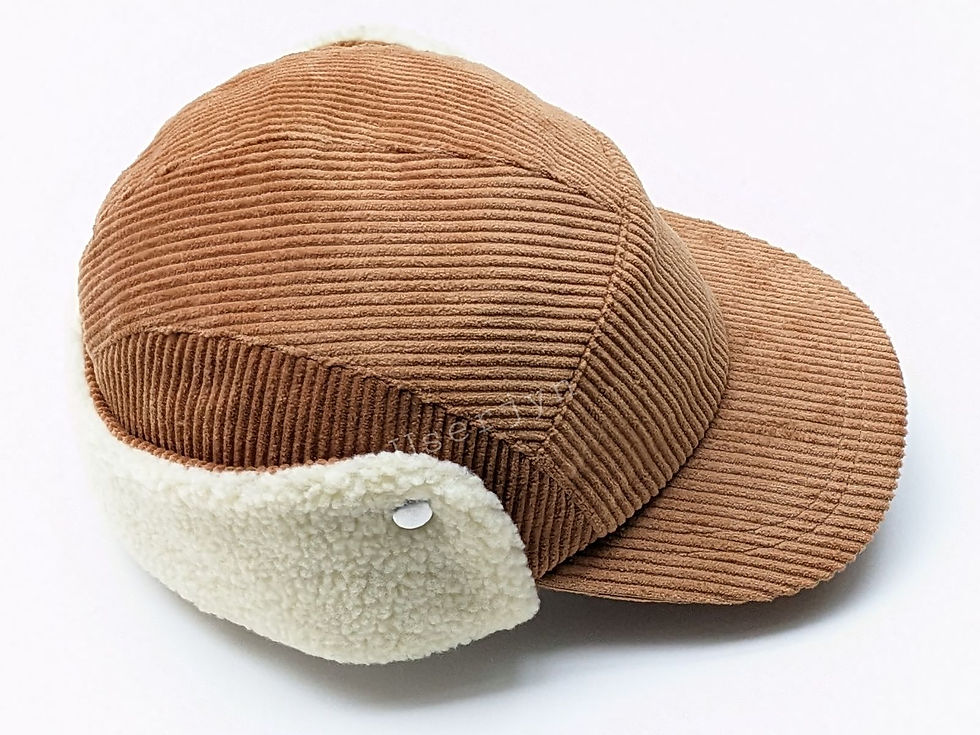Thumbnail: Brown corduroy winter cap with cream sherpa ear flaps.
