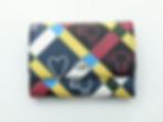 Vivienne Westwood wallet, colorful geometric pattern, heart and logo detail on white background.