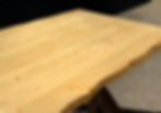 Restaurant table top handcrafted from reclaimed pine with faux live edge slab design and a natural wood tone.