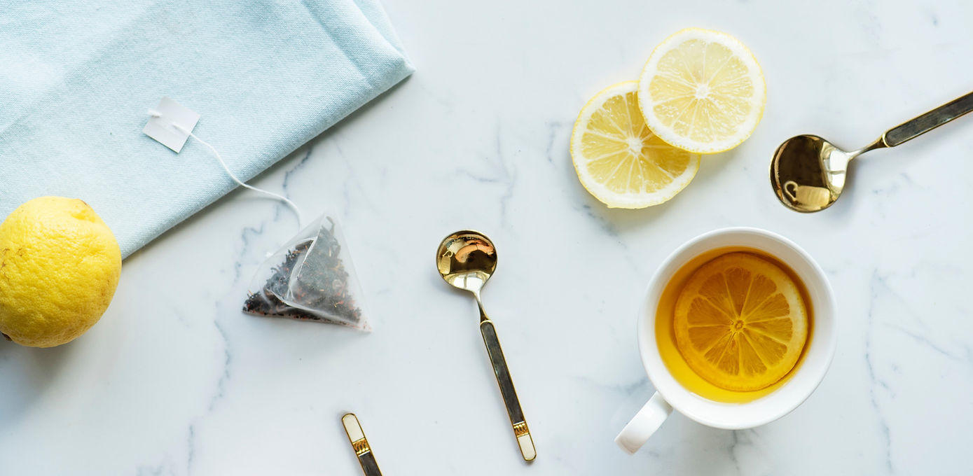 Marble countertop with gold cutlery and tea cups