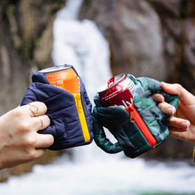 two people cheering their drinks with unique beer cozy on each drink