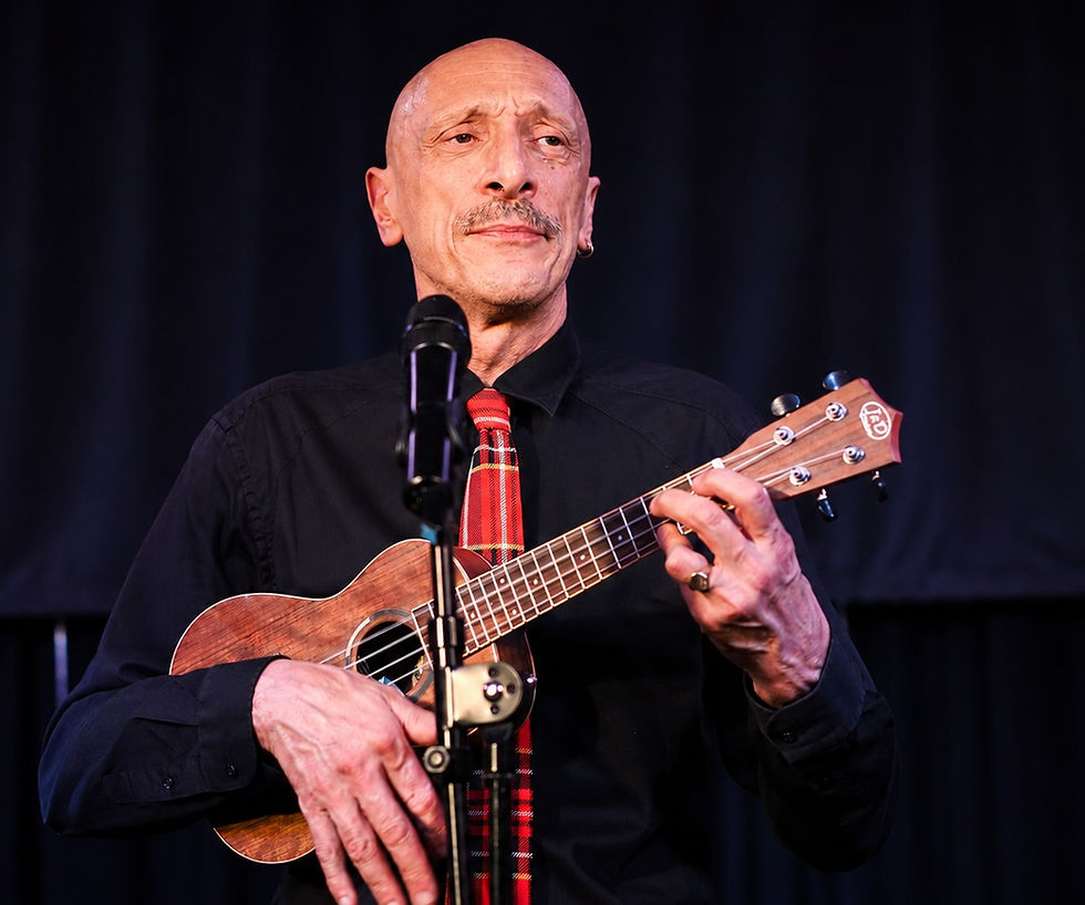 Turan Ali in black plus ukulele (tighter).jpg