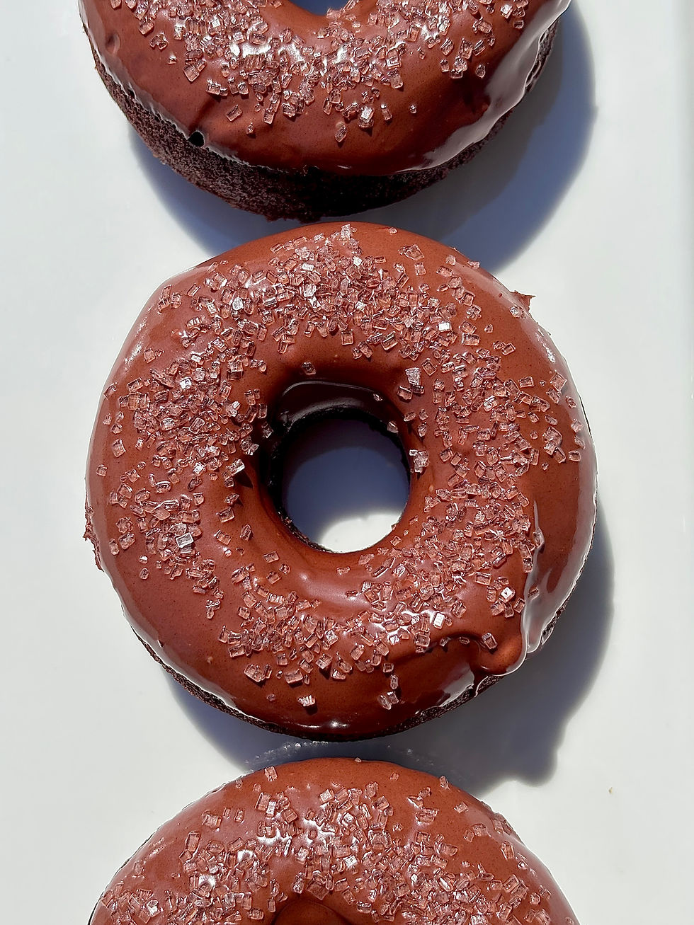 You'll be amazed by how chocolatey, tender, and delicious my Spelt Flour Chocolate Zucchini Donuts are, and no one will guess that zucchini is the primary ingredient. These donuts are made without oil and eggs, significantly lowering the fat, calories, and cholesterol, which I consider a win. They'll become a new favorite treat for the family.