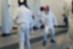 Teen fencers practicing bouts at Athena Fencing Club.