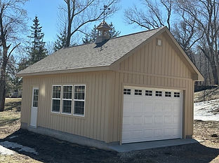 Finished custom garage shed with overhead door and windows built on site in Minnesota