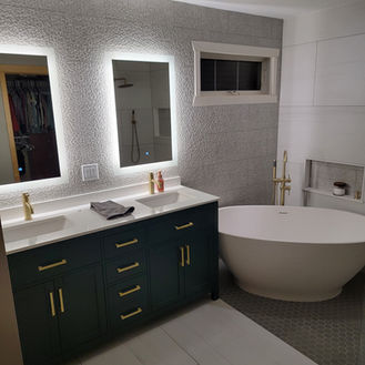 A full bathroom transformation with designer finishes—textured wall tile, large-format floors, and a clean modern layout. Built for a spa-like feel with tight details and a polished final look.