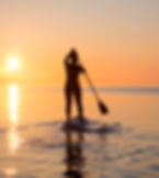 paddle boarding at sunset