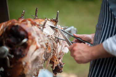 hog roast being carved for serving.jpg