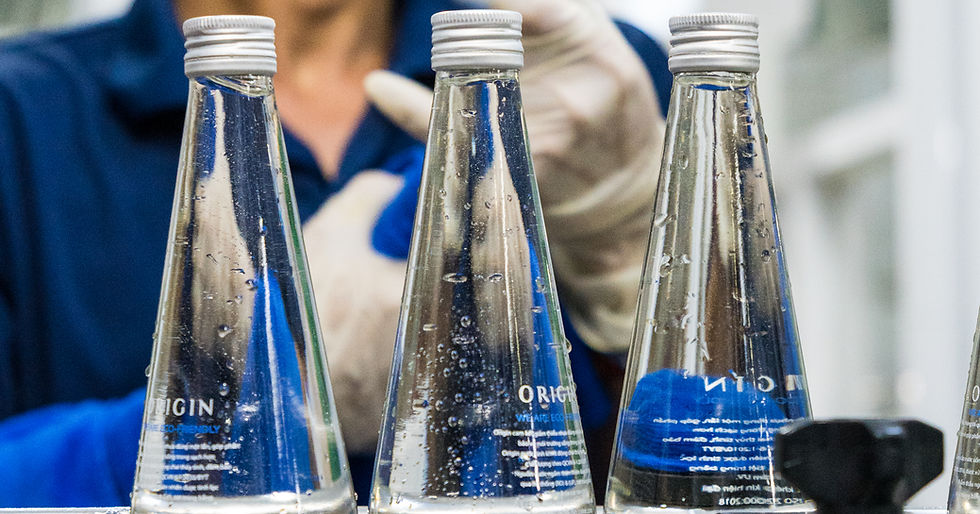 Three Origin water bottles waitingg to be checked and cleaned.
