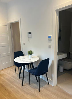 Modern apartment dining area with table and chairs